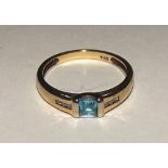 A gold aquamarine and diamond ring,