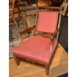 An American style mahogany armchair, with balustrade decoration, upholstered in red fabric,