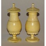 A pair of turned ivory pepper pots, circa late 19th/early 20th century, with detachable tops,