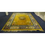A large Chinese carpet, decorated with floral medallion over yellow ground and blue floral border,
