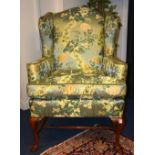 A William & Mary style wing armchair, upholstered in Chinese style green floral moquette, 127.