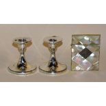 A pair of silver candlesticks, with rubbed hallmarks for Chester, 9cm high,