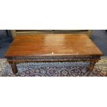 A stained stripped wood coffee table, of rectangular form,