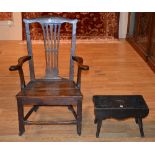 A 19th century country made elbow chair, with pierced splat and scroll arm rests,