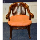 A Victorian mahogany Captain's style armchair, with rail supports and scroll arm rests,