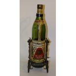 A German wrought iron bottle stand pourer, with large Meister-Brand bottle on pivot pour mechanism,