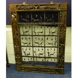 An African hardwood and iron wall sculpture, the frame carved with stylised animals and birds,