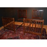 A pair of vintage mahogany framed single beds, with irons,