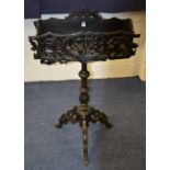 A Gothic style carved planter, decorated with pierced floral panels,