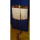 A vintage brass rise and fall ceiling light, with later fabric tassels and lead filled pulley,