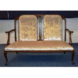 An Edwardian mahogany parlour settee, with scroll arm rests, upholstered in later velour,