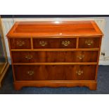 A modern yew wood chest of drawers, with three small drawers above two long drawers,