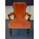 A Victorian rosewood framed open armchair, upholstered in later orange velour,