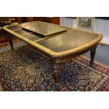 A Victorian oak telescope table, with three additional leaves, with tooled leather inset to top,