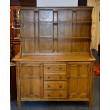 An Ercol 'Golden Dawn' dresser, with two tier delft rack above four small central drawers,