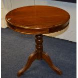 A reproduction tripod table, with circular top,