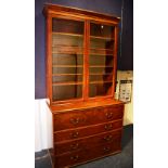 A mahogany bookcase on secretaire chest, circa early 19th century,