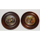 Two Prattware pot lids, within circular wood frames,