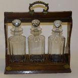 An oak three bottle Tantalus, circa early 20th century,