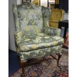 A William & Mary style wing armchair, upholstered in Chinese style green floral moquette,