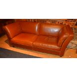 A contemporary tan leather two seater sofa,