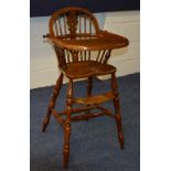 A Windsor style child's high chair, raised on turned columns,