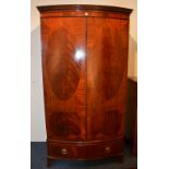 An Edwardian mahogany bow front wardrobe,