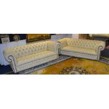 A pair of Chesterfield club style three seater leather sofas, in ivory coloured Connolly hide,