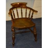 A vintage captain's chair, with hoop frame and spindle decoration,