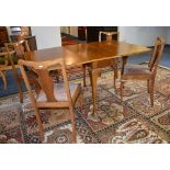 A vintage walnut gateleg table, with four splat back dining chairs, the table raised on pad foot,