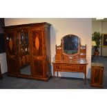 A late Victorian three piece mahogany inlaid bedroom suite, comprising of three door wardrobe,