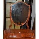 A reproduction shield shaped toilet mirror, raised on three drawer base,