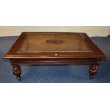 A mahogany coffee table, with rattan style bergere top, raised on reeded baluster supports,