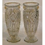 A pair of crystal vases, of lobed form, raised on circular foot,
