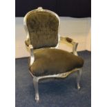 A reproduction silver painted parlour armchair, upholstered in grey buttonback velour,