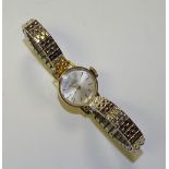 An 18ct gold lady's Girard Perregaux wristwatch, the champagne dial with baton numerals,