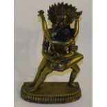 An Oriental brass erotic figure, displaying a couple in sexual embrace,