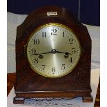 A mahogany cased mantel clock, with silvered dial,