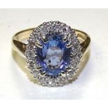 A 9ct gold tanzanite and diamond cluster ring,