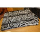 A faux leopard skin throw,