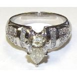 A platinum and diamond dress ring, the central pear cut diamond of pale yellow colour,