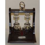 **A coromandel two bottle Tantalus circa late 19th/early 20th century,