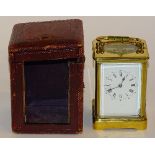 An antique repeating carriage clock, the white enamel dial with Roman and Arabic numerals,