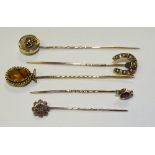 Five 9ct gold/yellow metal tie pins, two stamped 9ct; one set with amethyst and seed pearls,