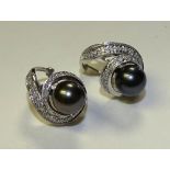 A pair of 14ct white gold black pearl and diamond earrings,