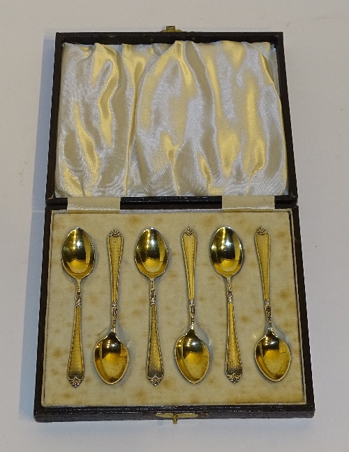 A cased set of six silver gilt coffee spoons, hallmarks for Birmingham 1934 Adie Brothers,