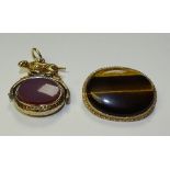 A yellow metal hound fob, the oval inset with bloodstone agate and pink cornelian,