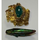 A yellow metal and green agate brooch, thought to be Indian gold originally,