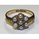 A 9ct gold pearl flowerhead ring, stamped 375 to underside, ring size O, 2.