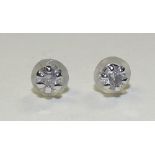 A pair of platinum diamond earrings, set with single brilliant cut diamond to each earring,